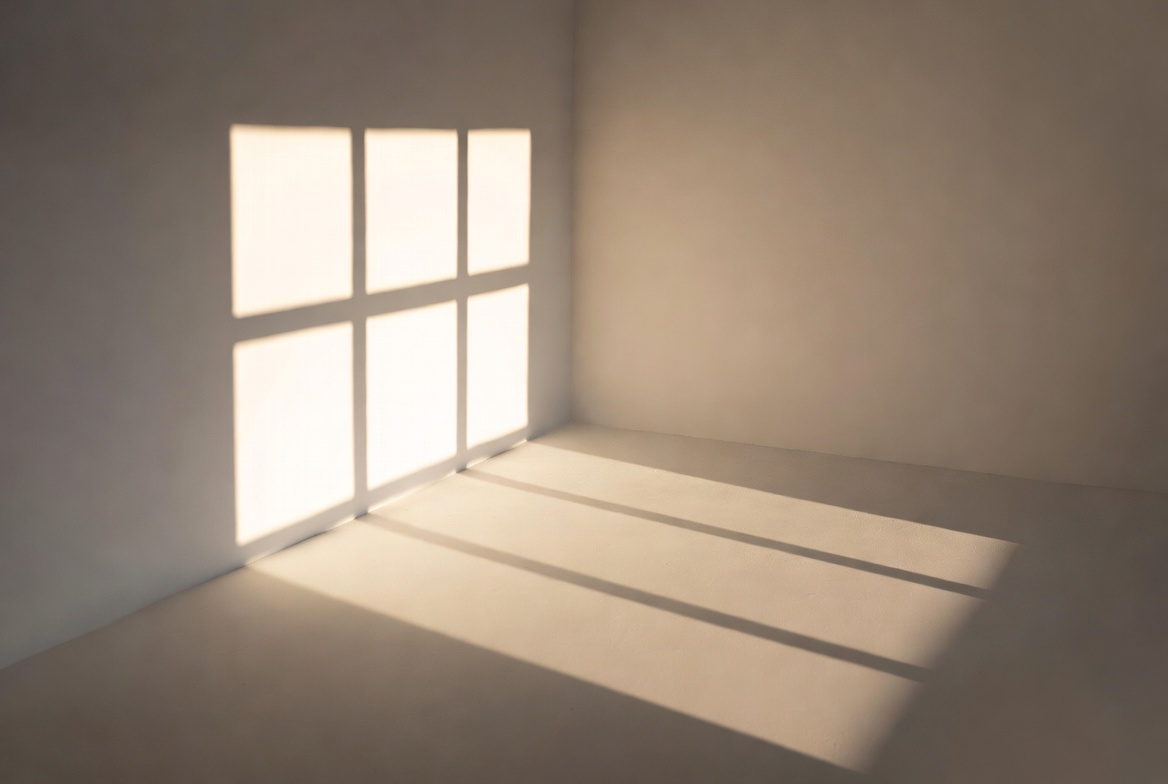 Gentle light and shadow patterns from a window falling across a plain floor and wall in a minimal room. Clean lines and soft gradients in serene neutral tones.